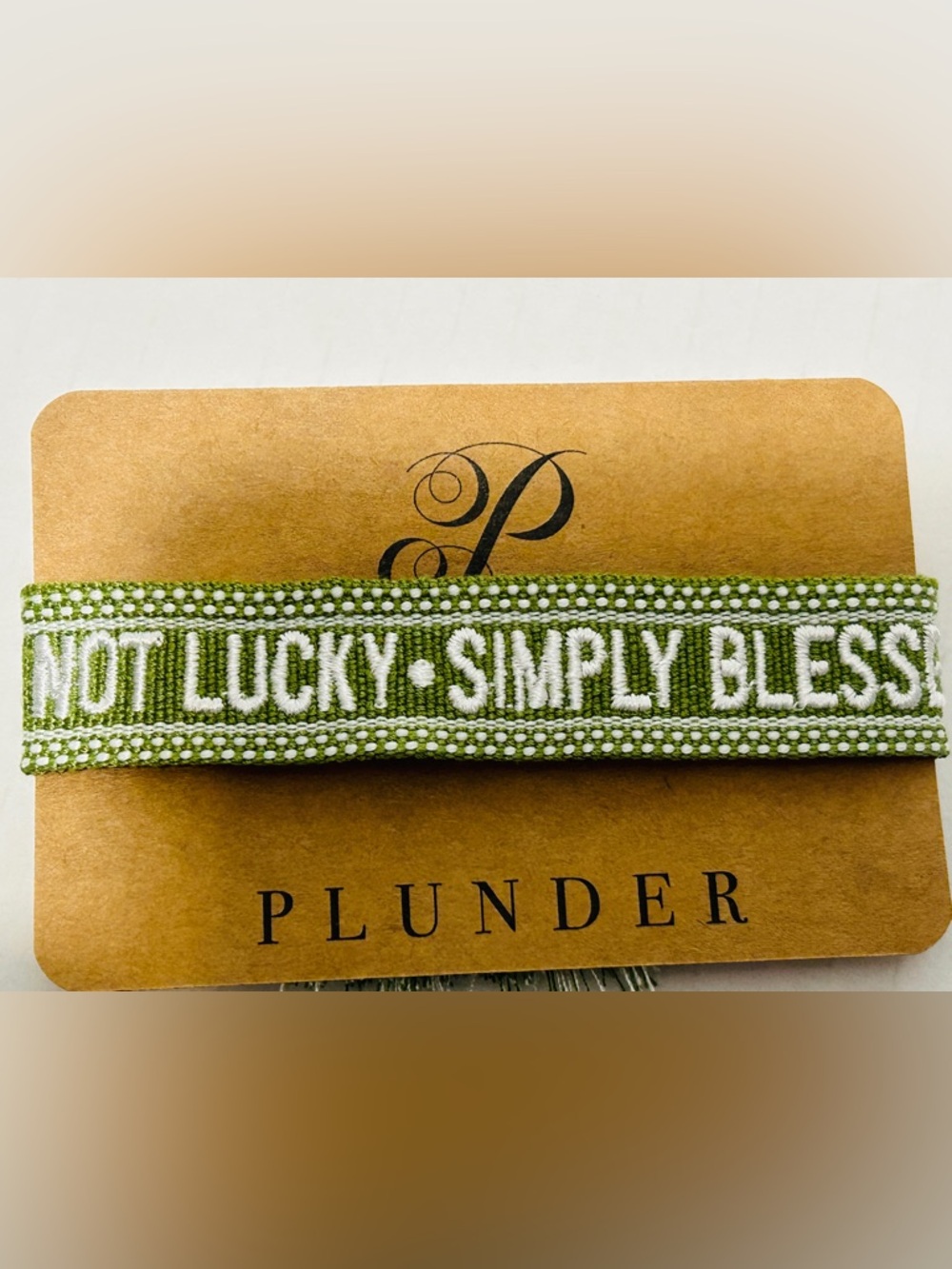 Plunder Green Woven Ribbon Bracelet with White Embroidery.